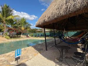 a resort with a hammock and a swimming pool at Hameki in Homún