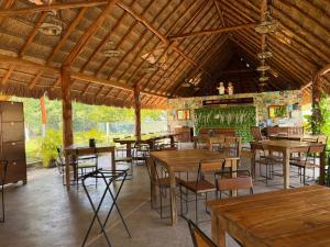 a dining room with wooden tables and chairs at Hameki in Homún