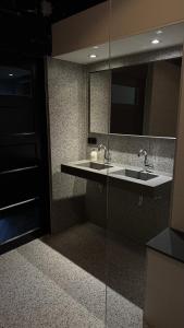 a bathroom with a sink and a mirror at BBgebouw39 - op de Rijkswerf in Den Helder +21 photos