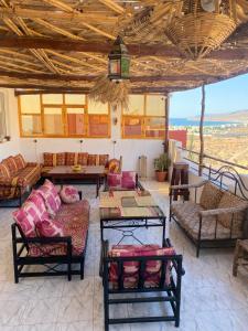 a living room with couches and a table at Red Carpet Surf Camp Tamraght , Sea & Mountain View, Surf Lessons Available in Tamraght Ouzdar