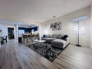 a living room with a couch and a table at Stylish & Fully Renovated Home! in Oxnard