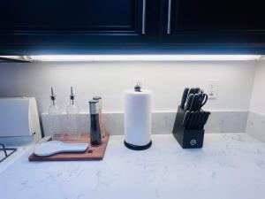 a counter top with bottles and a paper towel at Stylish & Fully Renovated Home! in Oxnard