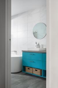 a bathroom with a blue vanity and a mirror at 13 Mountbatten in Bright +36 photos