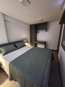 a bedroom with a large bed in a room at Apartamento Edifíco Prestige in Marechal Deodoro +16 photos