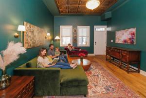 a group of people sitting on a couch in a living room at Velvet Haus Downtown 3rd Floor Deck Backyard in Cincinnati +36 photos