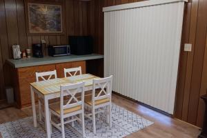 a kitchen with a table and chairs and a counter at Cozy Cabin in Packwood in Randle
