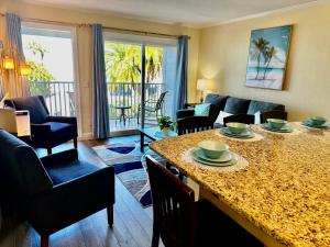 a living room with a table with chairs and a couch at This could be your view every night of your stay!! Cozy, comfy remodeled condo! in Tampa