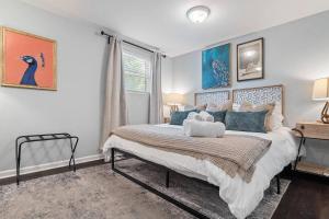 a bedroom with a large bed with blue pillows at *Super close to Hospitals|UAB|Open fl plan|2 bdr in Birmingham