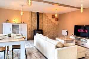 a living room with a couch and a fireplace at L'instant Douceur in Riorges
