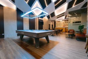 a pool table in the middle of a room at RAI ATRIUM SUITES HOTEL - Cauayan in Cauayan City