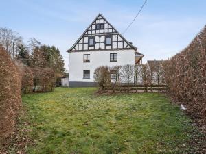 a large white house with a fence in the yard at Schwermann in Schmallenberg