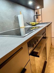 a kitchen with a counter top with a sink at DESIGNBUTZE by BUTZENFLOTTE Grömitz - Beach Loft & Meerblick in Grömitz