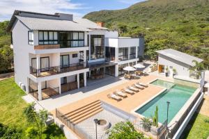 an aerial view of a house with a swimming pool at Casa do Valle Hotel Boutique - Vale do Capão in Vale do Capao