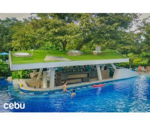 a model of a swimming pool with people in the water at Condotel in Tambuli Seaside Studio - F21K in Maribago