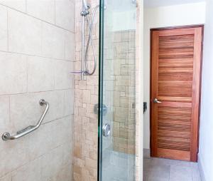 a shower with a glass door in a bathroom at Sea Palace in Philipsburg +105 photos