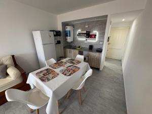 a white table and chairs in a small kitchen at Ambar Estudio in Miramar