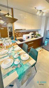 a table with plates on it in a kitchen at Condotel in Tambuli Seaside Studio - F21K in Maribago