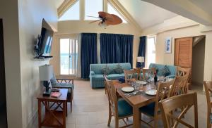 a living room with a table and a couch at Sea Palace in Philipsburg