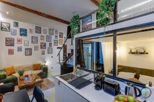 a kitchen with a sink and a living room at Chic Industrial Loft Quiet Garibaldi AC Balcony in Nice +22 photos