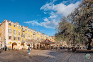 a city square with a large yellow building at Chic Industrial Loft Quiet Garibaldi AC Balcony in Nice