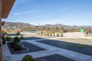 a resort with a pool and mountains in the background at Villas Persas by Jardin de Persia in Valle de Guadalupe