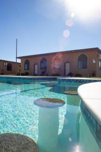 a swimming pool with blue water in front of a building at Villas Persas by Jardin de Persia in Valle de Guadalupe