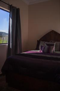 a bedroom with a bed and a window with a view at Villas Persas by Jardin de Persia in Valle de Guadalupe +28 photos