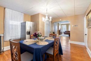 a dining room with a blue table and chairs at Candlelight Chamber - Private Room with Shared Space in Chester