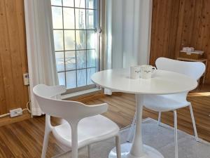 a white table and chairs in a room with a window at Wando Haegeum Pension in Wando
