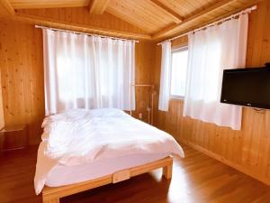 a bedroom with a bed and a window and a tv at Wando Haegeum Pension in Wando +28 photos