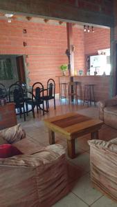 a living room with a coffee table and chairs at Casa Paganelli Germano in Aristóbulo del Valle
