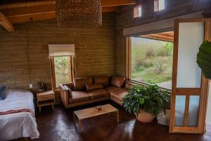 ein Wohnzimmer mit Sofa und Fenster in der Unterkunft Hangar 5 in San Lucas del Pulque