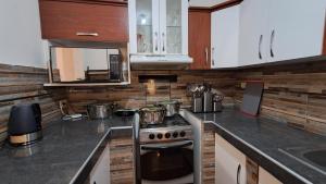 a kitchen with a stove and a microwave at Modern Apartament Pool & Jacuzzi 2 room in Lima