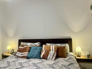 a bedroom with a bed with pillows on it at M&Js Place in Cebu City