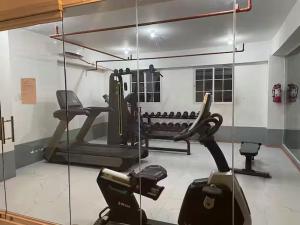 a gym with several exercise equipment in a room at M&Js Place in Cebu City
