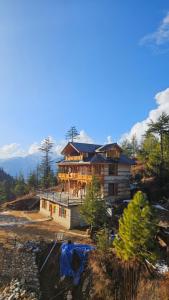 a house under construction on top of a hill at Himalayan Baseraa in Sainj