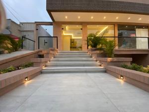 a house with stairs and lights in front of it at BQ84 Urban Hotel in Barranquilla