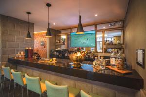 a bar in a restaurant with colorful chairs at Hampton By Hilton Cusco in Cusco