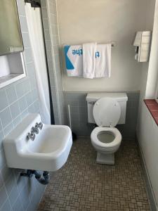 a bathroom with a white toilet and a sink at Central YMCA Residences in Honolulu +34 photos