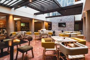 a restaurant with tables and chairs in a room at Hampton By Hilton Cusco in Cusco