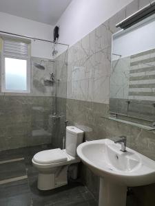 a bathroom with a toilet and a sink at EZ Colombo Stay in Colombo