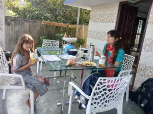 two girls sitting at a table with drinks at Penuel marari homesty in Mararikulam +19 photos