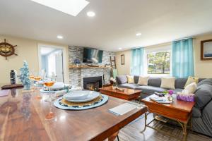 a living room with a couch and a table at Cape Seacret in South Yarmouth