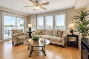 a living room with a couch and a table at Captains Watch in Tybee Island