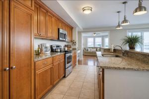 a kitchen with wooden cabinets and a counter top at Captains Watch in Tybee Island