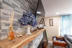 a room with a counter with a vase of blue flowers at Cape Seacret in South Yarmouth