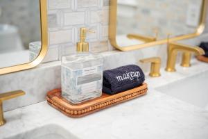 a bathroom sink with a bottle of soap and a towel at Cape Seacret in South Yarmouth +50 photos