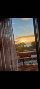 a view of the sunset from a window of a ship at Cabaña Playa Rosada in Valdivia