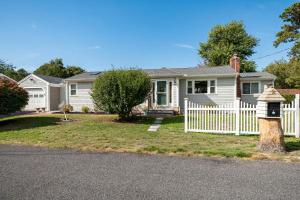 a white fence in front of a house at Cape Seacret in South Yarmouth