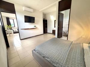 a bedroom with a bed and a tv on the wall at Moro Apartments - Near the beach in Cancún